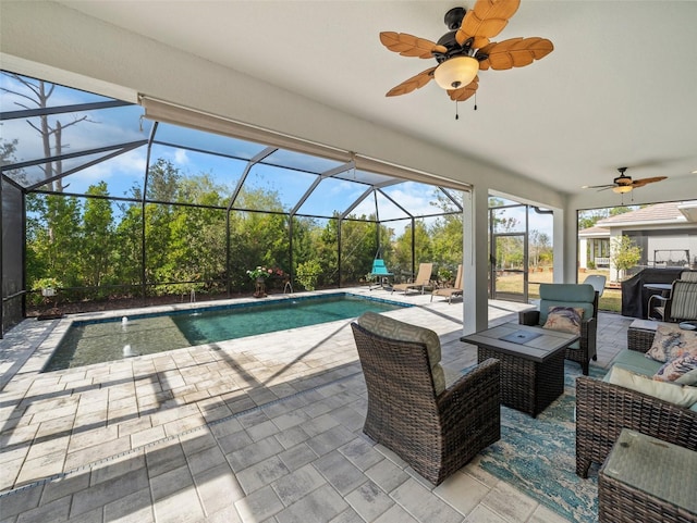 view of swimming pool featuring an outdoor living space, a patio, ceiling fan, and glass enclosure