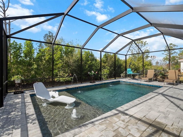 view of pool with pool water feature, a patio area, and a lanai