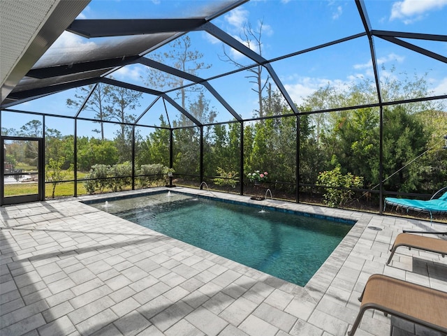 view of swimming pool featuring a lanai and a patio