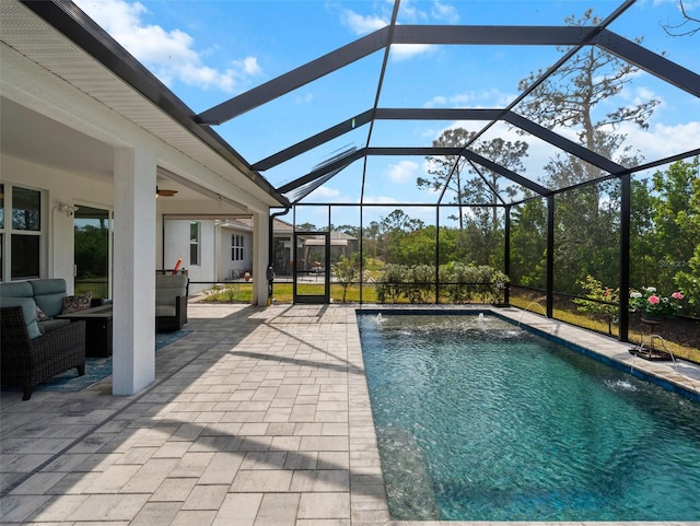 view of pool with a lanai, ceiling fan, an outdoor living space, a patio area, and pool water feature