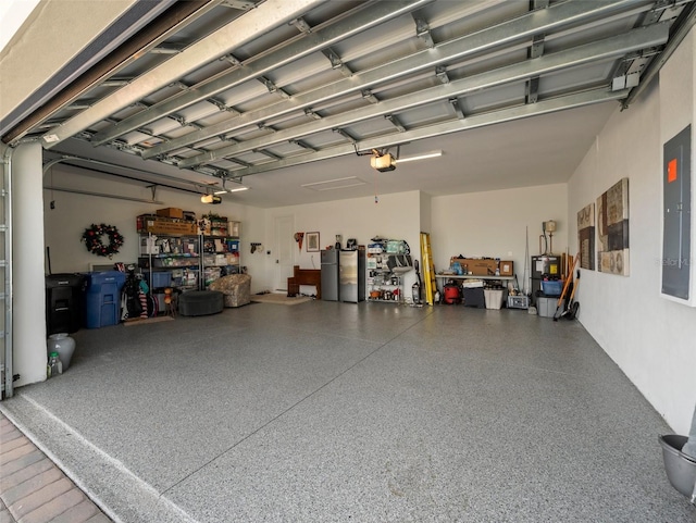 garage with a garage door opener and electric panel