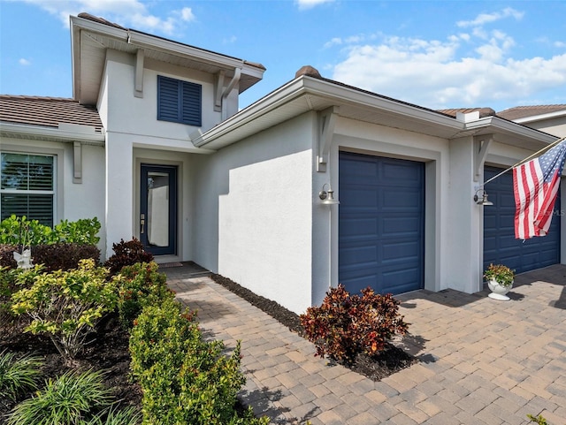 view of exterior entry featuring a garage