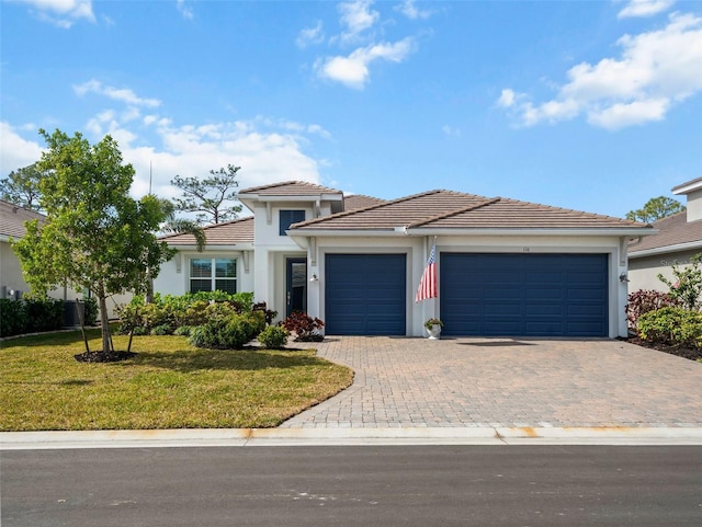 view of front of property featuring a garage and a front yard