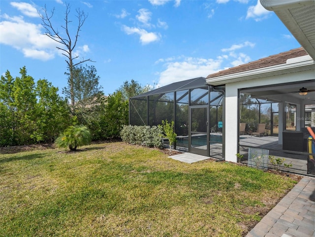 view of yard featuring a patio area and glass enclosure