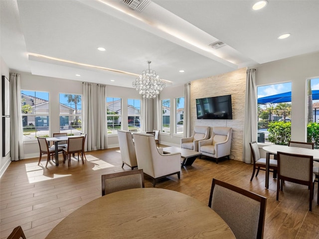 living room featuring light hardwood / wood-style floors and a notable chandelier