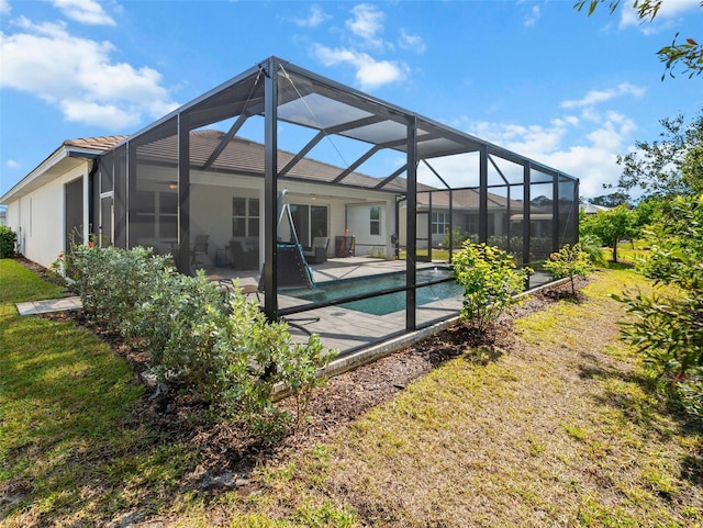 rear view of house with a patio, a lanai, and a yard