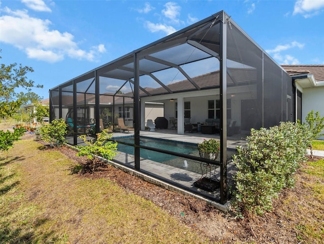 back of house with a lanai and a patio