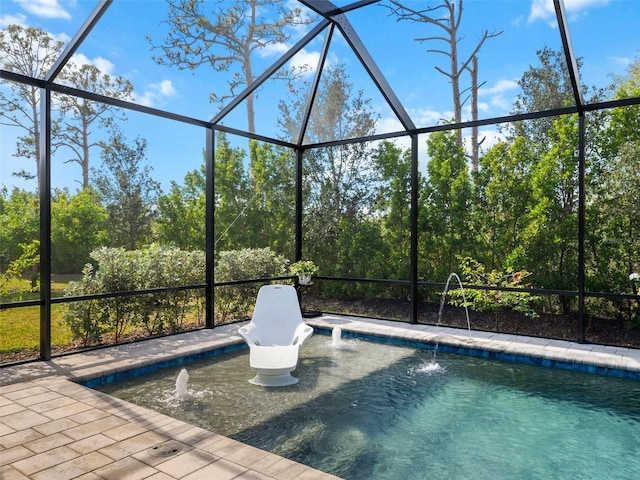 view of pool featuring pool water feature, a patio area, and glass enclosure