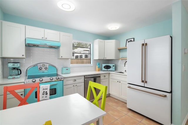 kitchen featuring dishwasher, high end fridge, sink, and white cabinets