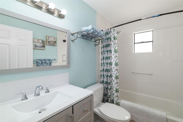 full bathroom with shower / tub combo with curtain, vanity, and toilet