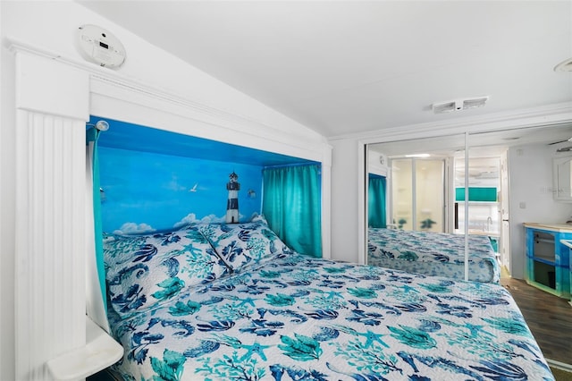 bedroom with lofted ceiling and wood-type flooring