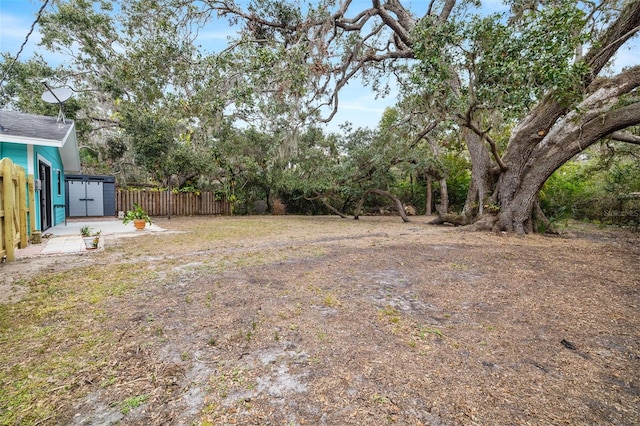 3200 Tobero Ln, Sarasota, FL 34235 - view of yard with a storage unit, fence, and an outbuilding