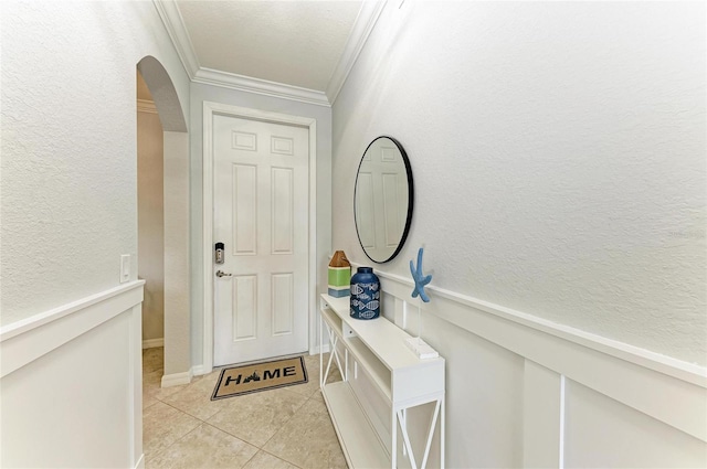 entryway featuring ornamental molding and light tile patterned flooring