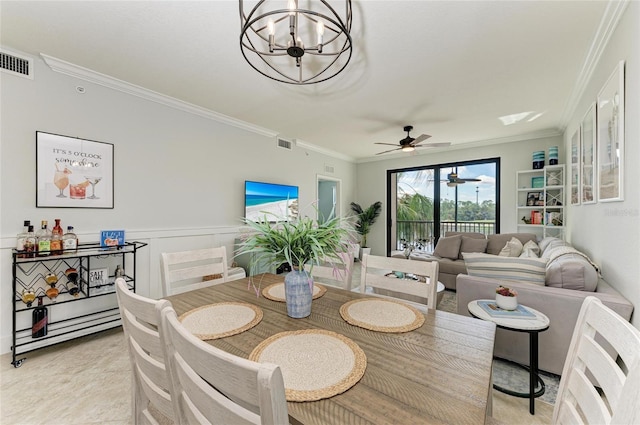 dining space featuring ornamental molding and a chandelier