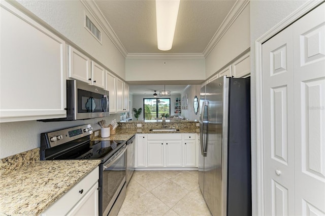 kitchen with white cabinetry, appliances with stainless steel finishes, sink, and ornamental molding