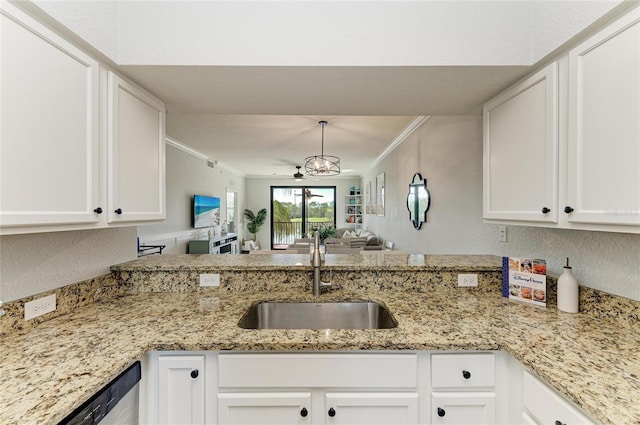 kitchen featuring decorative light fixtures, white cabinetry, sink, ornamental molding, and stainless steel dishwasher