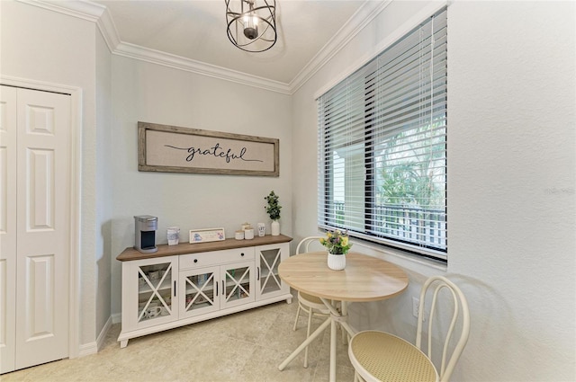 dining room with an inviting chandelier and ornamental molding