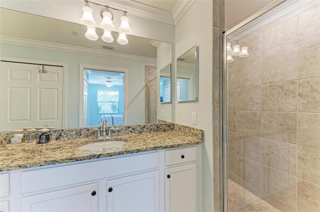 bathroom with crown molding, vanity, and a shower with shower door