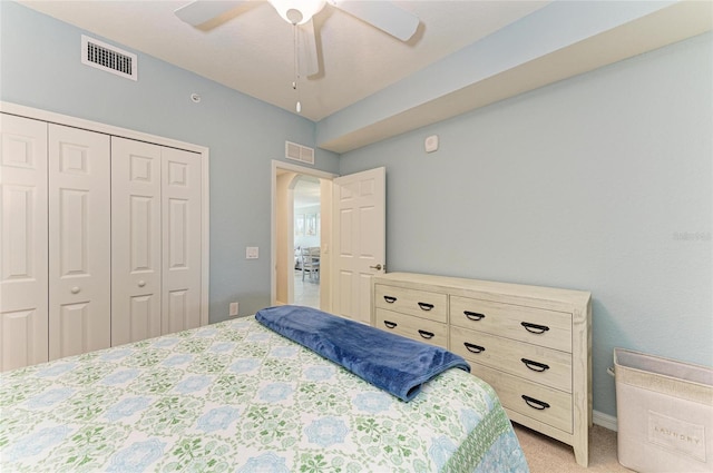 carpeted bedroom featuring a closet and ceiling fan