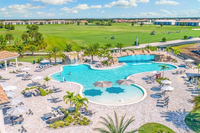 view of swimming pool with pool water feature