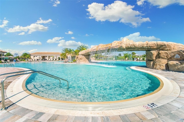 view of swimming pool with pool water feature