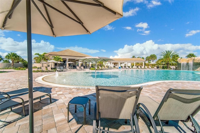 view of pool featuring pool water feature and a patio