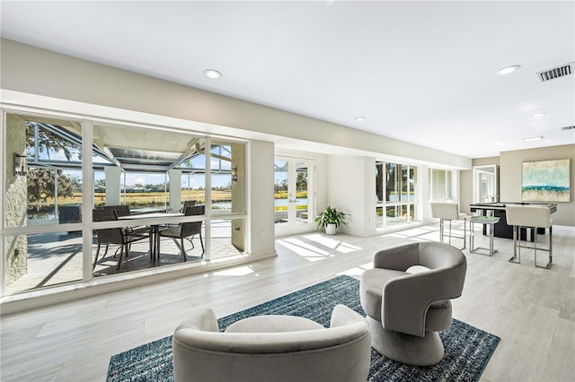 living room featuring french doors and light hardwood / wood-style flooring