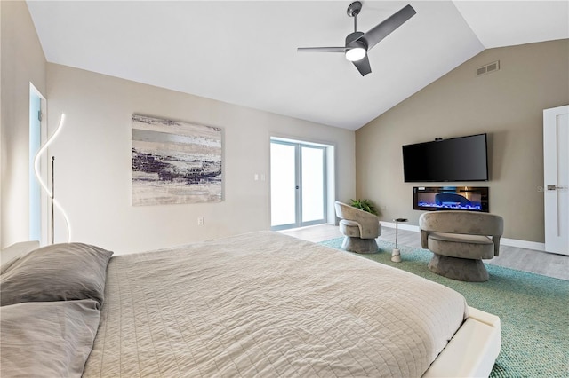 bedroom with vaulted ceiling, hardwood / wood-style floors, and ceiling fan