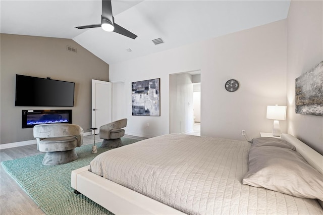 bedroom with vaulted ceiling, wood-type flooring, and ceiling fan