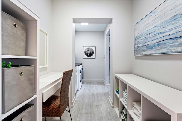 laundry room featuring washing machine and clothes dryer and light wood-type flooring