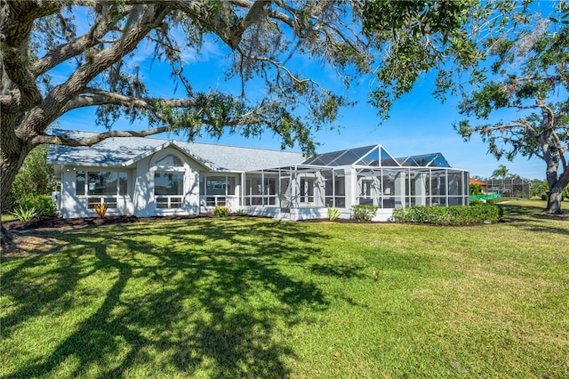 back of property featuring a yard and a lanai