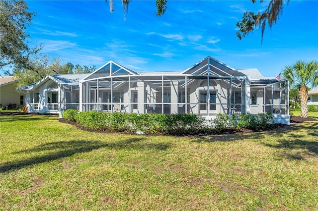 rear view of property featuring a lanai and a lawn