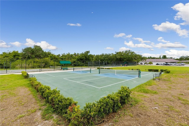 view of sport court featuring a lawn