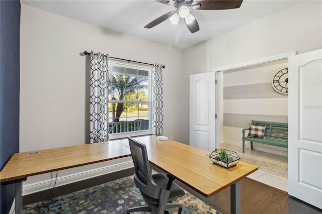 office space with dark wood-type flooring and ceiling fan