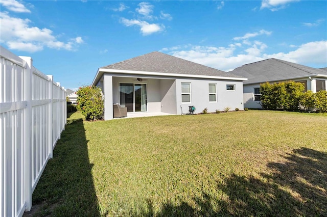 back of house featuring a yard