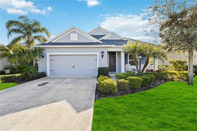 10931 Blue Magnolia Ln, Parrish, FL 34219 - ranch-style home featuring a garage, a front yard, driveway, and covered porch