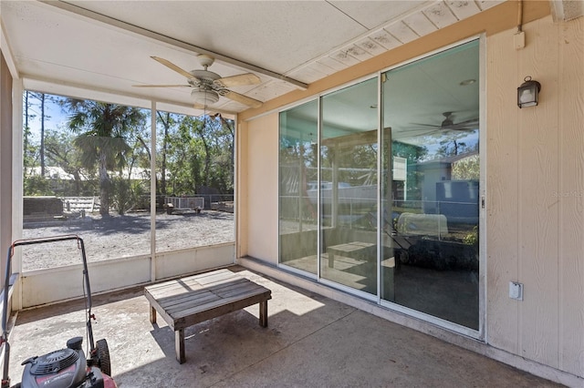 unfurnished sunroom with ceiling fan