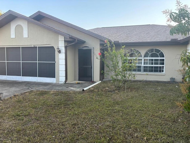 view of front of property with a garage and a front lawn