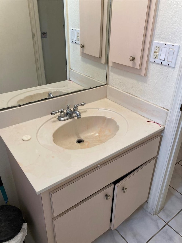 bathroom with tile patterned flooring and vanity