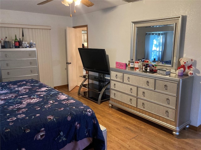 bedroom with ceiling fan and light wood-type flooring