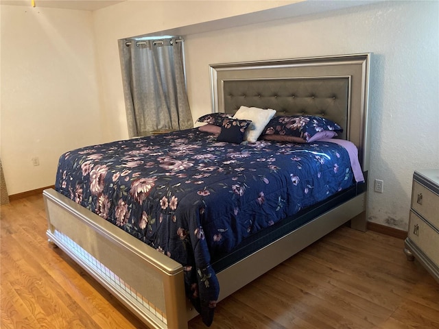 bedroom with hardwood / wood-style floors