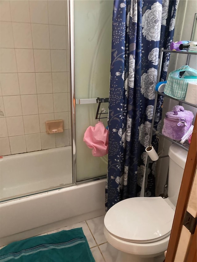 bathroom featuring shower / bathtub combination with curtain, tile patterned floors, and toilet