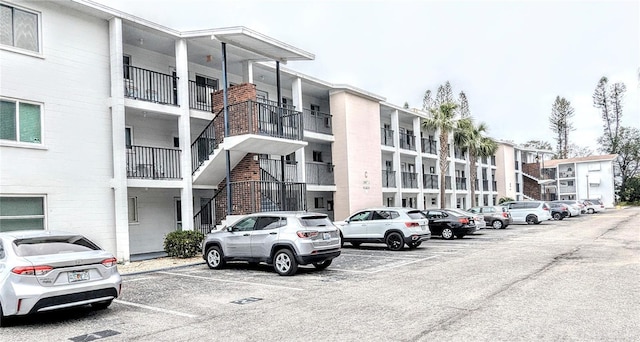 view of building exterior featuring uncovered parking