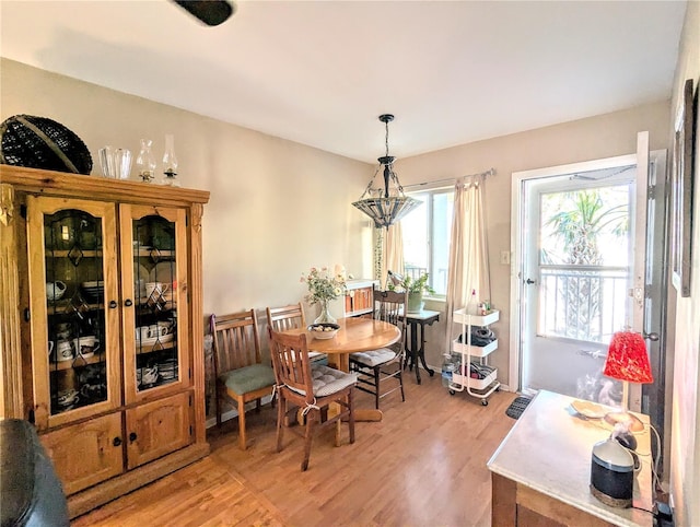 dining room with an inviting chandelier and light wood-type flooring