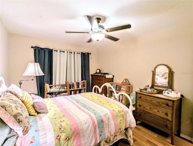 bedroom with ceiling fan and light hardwood / wood-style floors