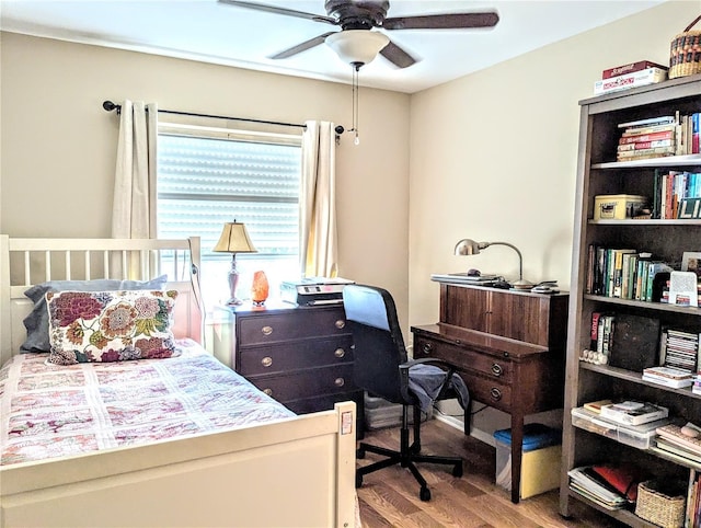 bedroom with ceiling fan and wood-type flooring