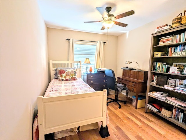 bedroom featuring a ceiling fan and light wood finished floors