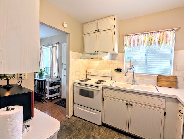 kitchen with a sink, under cabinet range hood, light countertops, and white range with electric cooktop