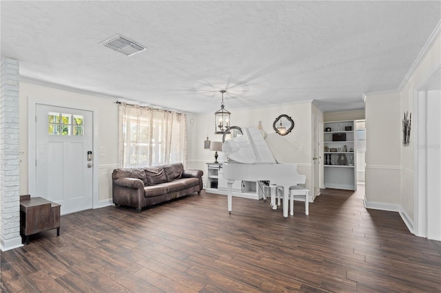 living room with crown molding, dark hardwood / wood-style floors, and a textured ceiling