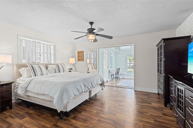 bedroom with dark hardwood / wood-style flooring, ceiling fan, and a textured ceiling